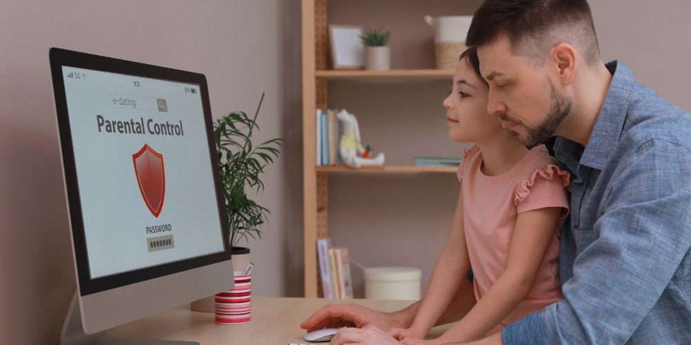 dad-installing-parental-control-on-computer-at-table