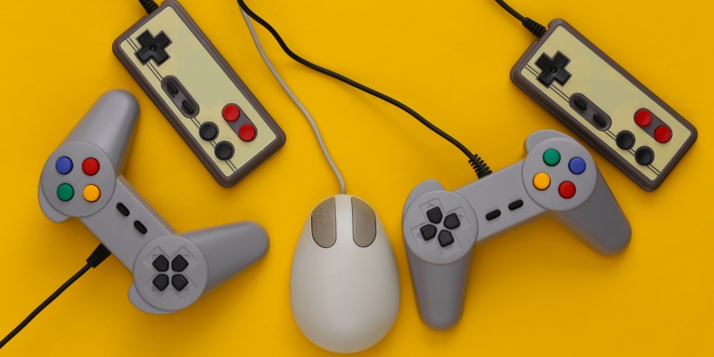 retro-joysticks-and-pc-mouse-on-a-yellow-background-retro-gaming-gaming-devices-gadgets