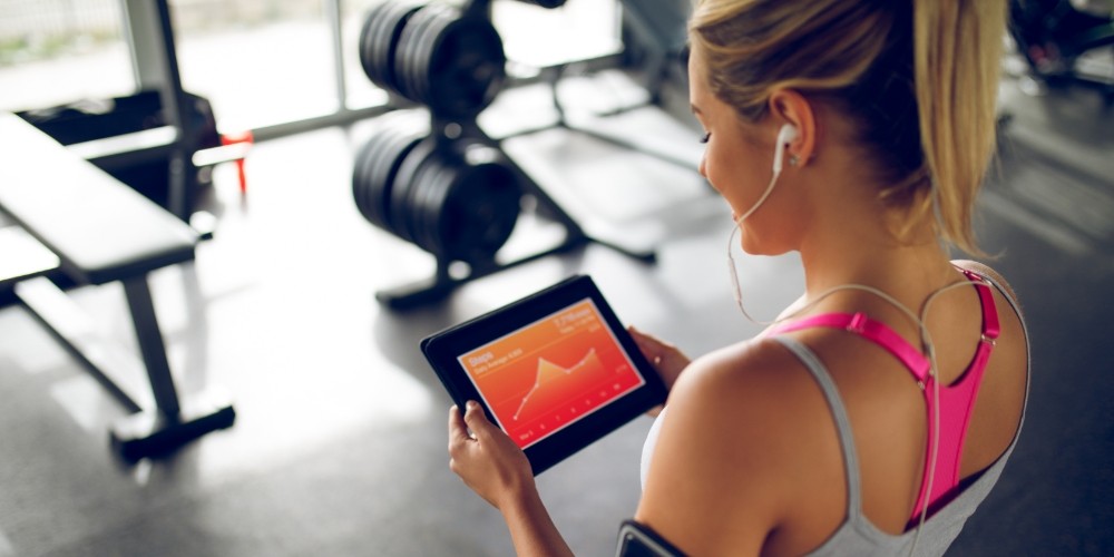 tracking-her-progress-with-fitness-app-on-digital-table